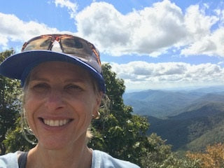 Marie on a sunny hike high up on a hill.