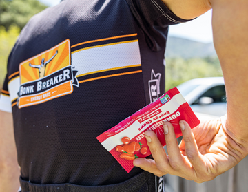 Biker putting Strawberry Energy Chews into shirt pocket