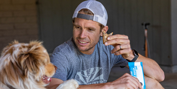 jason eating a bonk breaker bar with his dog