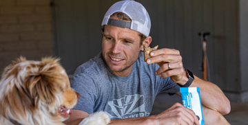 jason eating a bonk breaker bar with his dog 