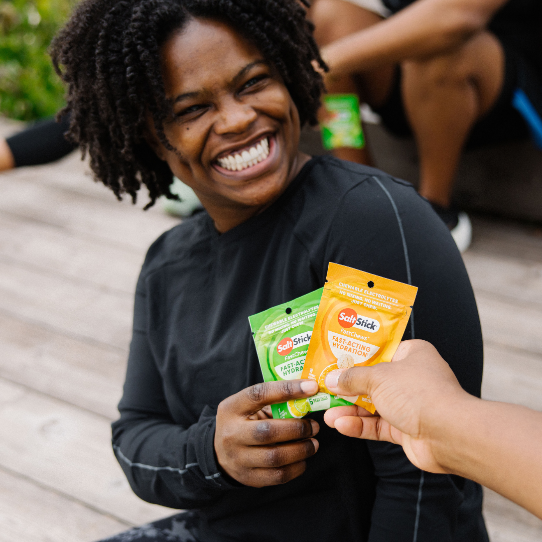 athlete holding a packet of orange and lemon lime fastchews