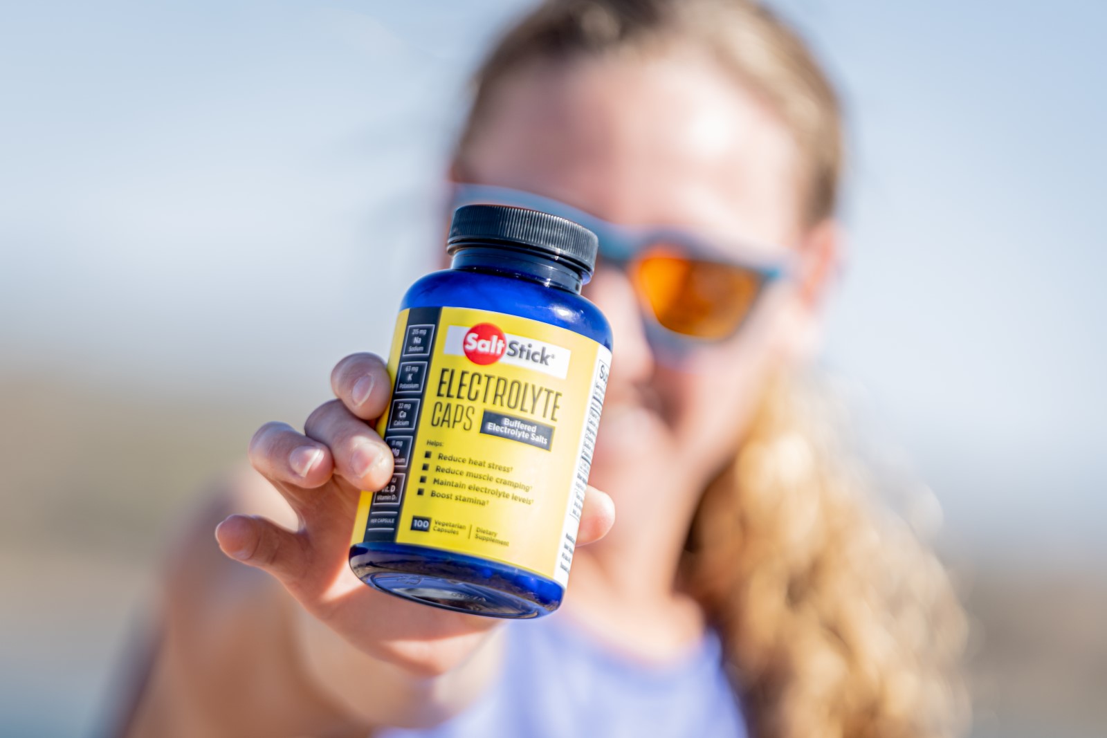 Athlete holding a bottle of SaltStick Electrolyte Capsules