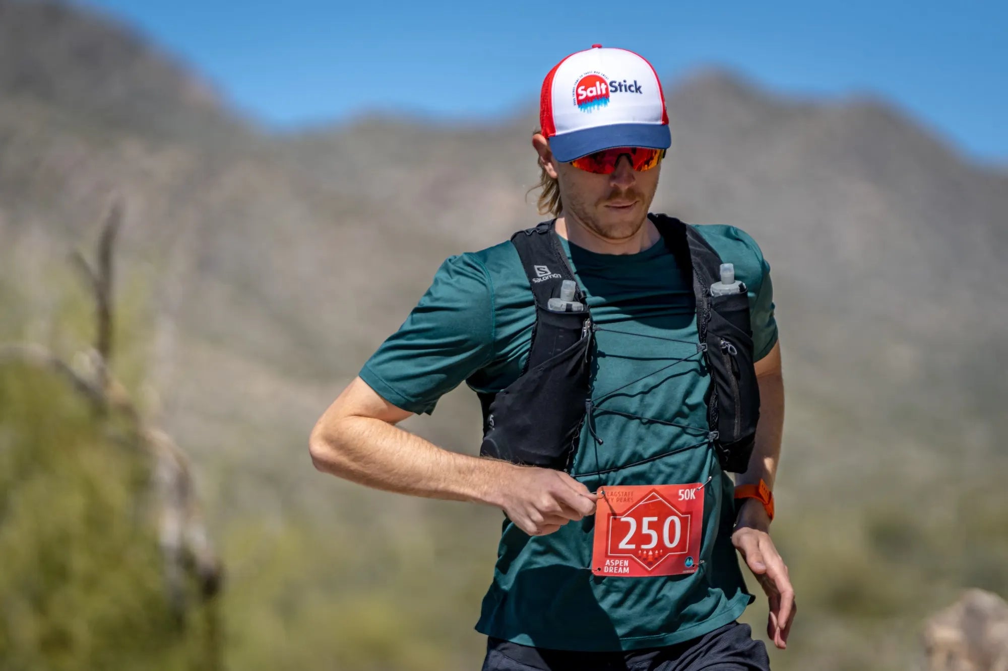 Runner on a trail run wearing a SaltStick cap.