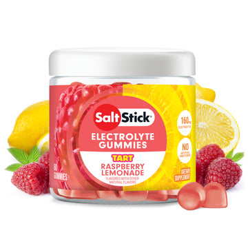 A jar of Salt Stick Electrolyte Gummies in Tart Raspberry Lemonade flavor, surrounded by fresh raspberries, lemons, and a few loose gummies on a white background.