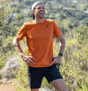 Jason smiling on a break from a run in nature.