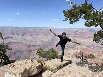 Joseph balancing on one leg near the edge of the Grand Canyon -- yikes!