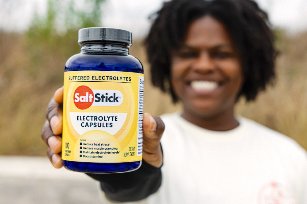 Athlete holding a bottle of SaltStick Electrolyte Capsules