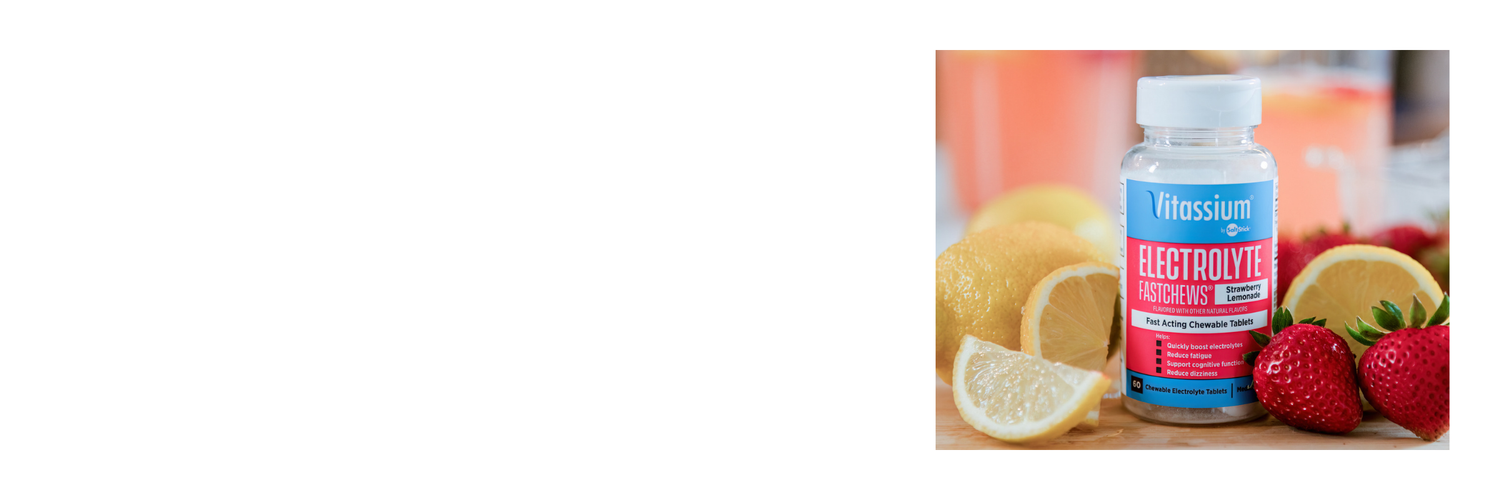 Vitassium by SaltStick Electrolyte FastChews in Strawberry Lemonade flavor, 60 fast-acting chewable tablets, shown beside fresh lemons and strawberries.