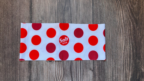 White headband with red polka dots and SaltStick logo inside one of the red dots. 